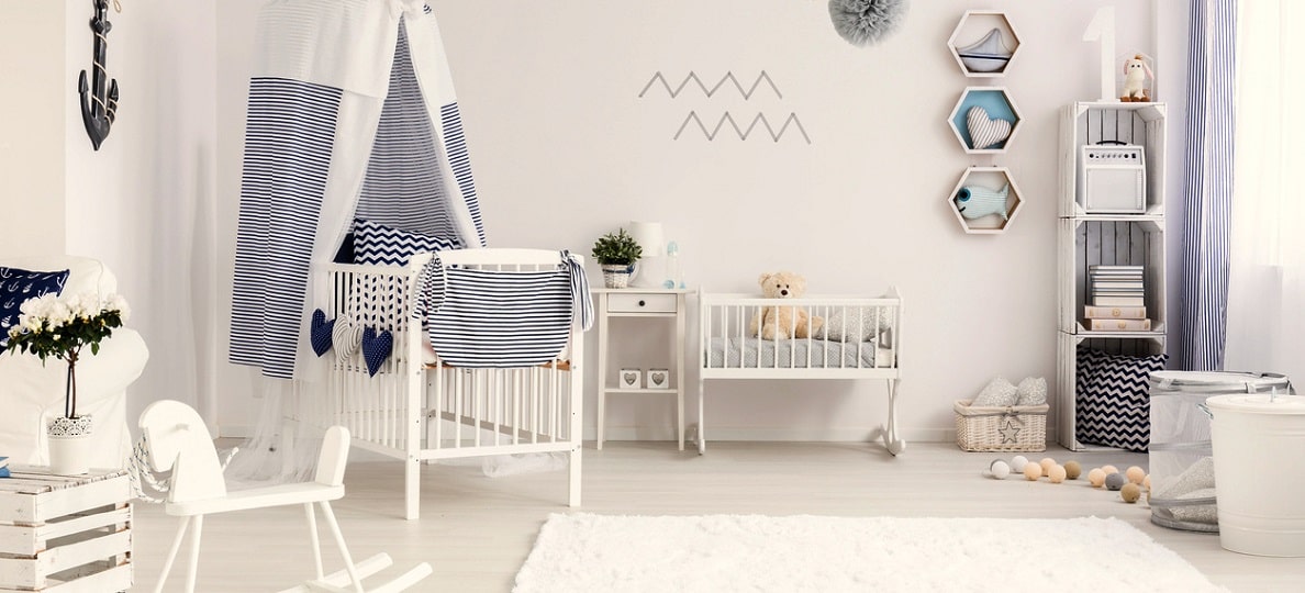 Kids room with white rug, white wooden baby bed, white wooden horse wardrobe anchor white rug in nursery room
